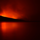 A night view of the Howe Ridge Fire on the shores of Lake McDonald.